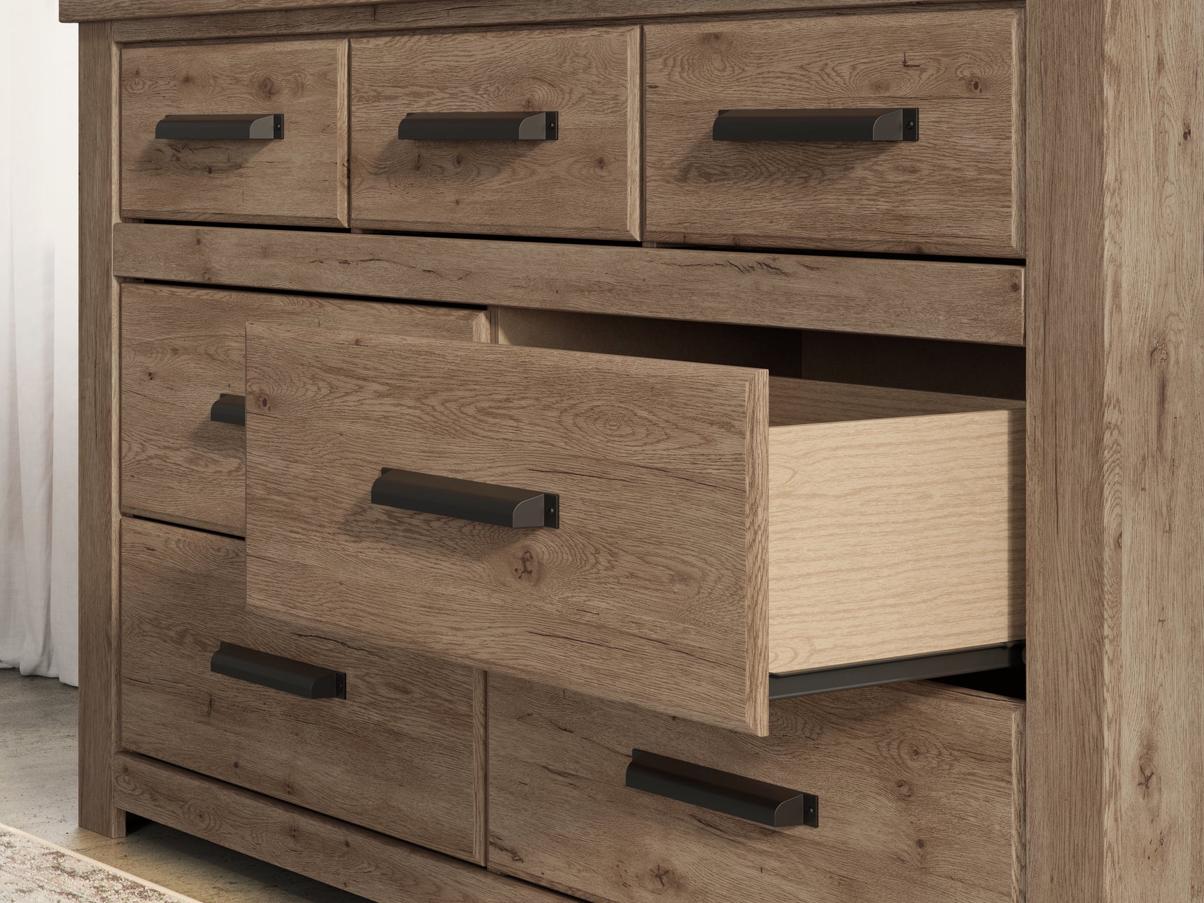 Close-up of dresser drawer handle and wood grain