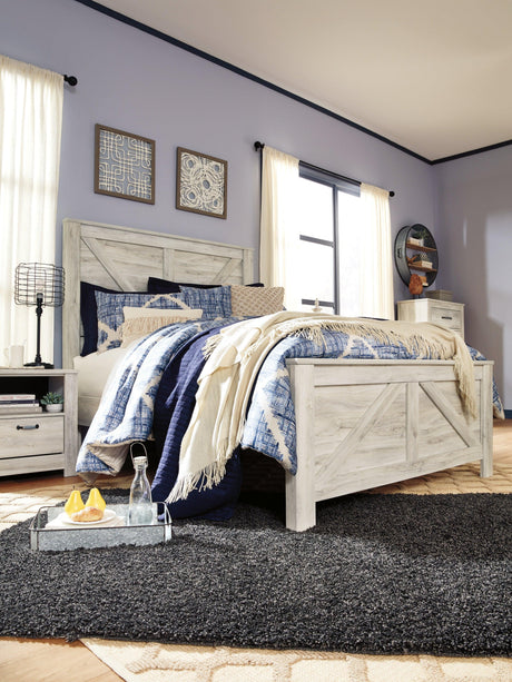 Bellaby Whitewash Queen Crossbuck Panel Bed styled in bedroom