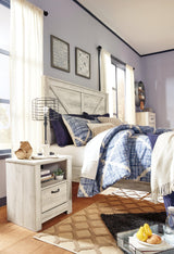 Bellaby King Crossbuck Panel Bed styled with bedding
