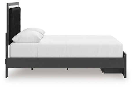 Side profile view of black upholstered panel bed