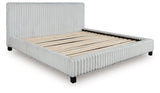 Nightstand positioned with Zuraleus White King Upholstered Bed angle view