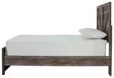 Side profile of Wynnlow Gray Twin Crossbuck Panel Bed