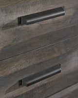 Wynnlow Gray 5-Drawer Chest distressed gray wood finish close-up