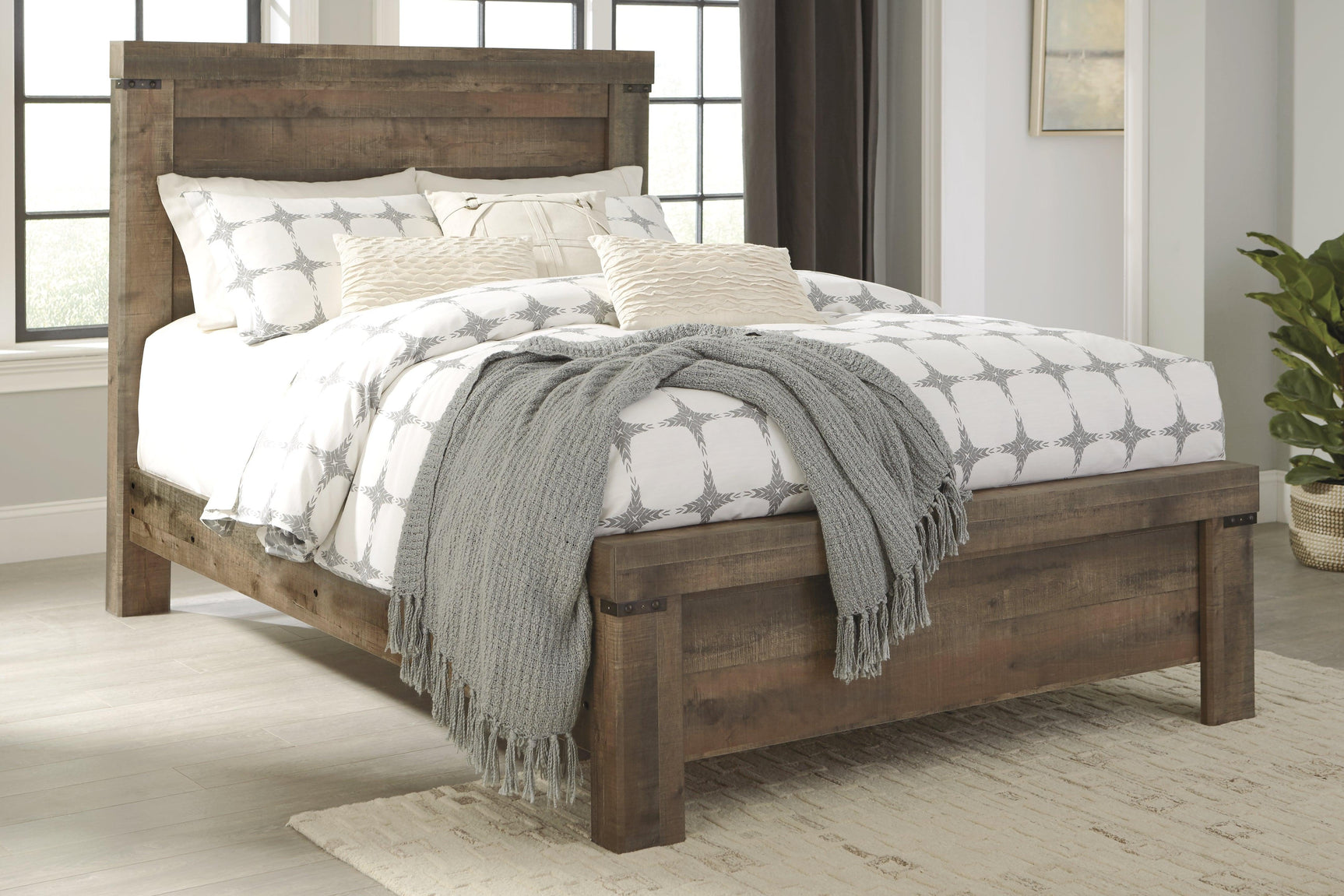 Trinell Brown Queen Panel Bed close-up of nailhead trim