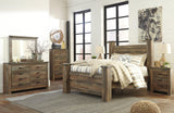 Poster bed posts with intricate details on Trinell Brown Queen Bed