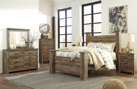 Poster bed posts with intricate details on Trinell Brown Queen Bed