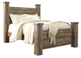 Side angle showing padded upholstered headboard of Trinell Queen Poster Bed