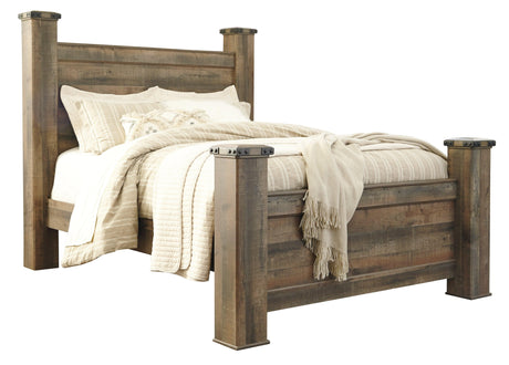 Side angle showing padded upholstered headboard of Trinell Queen Poster Bed