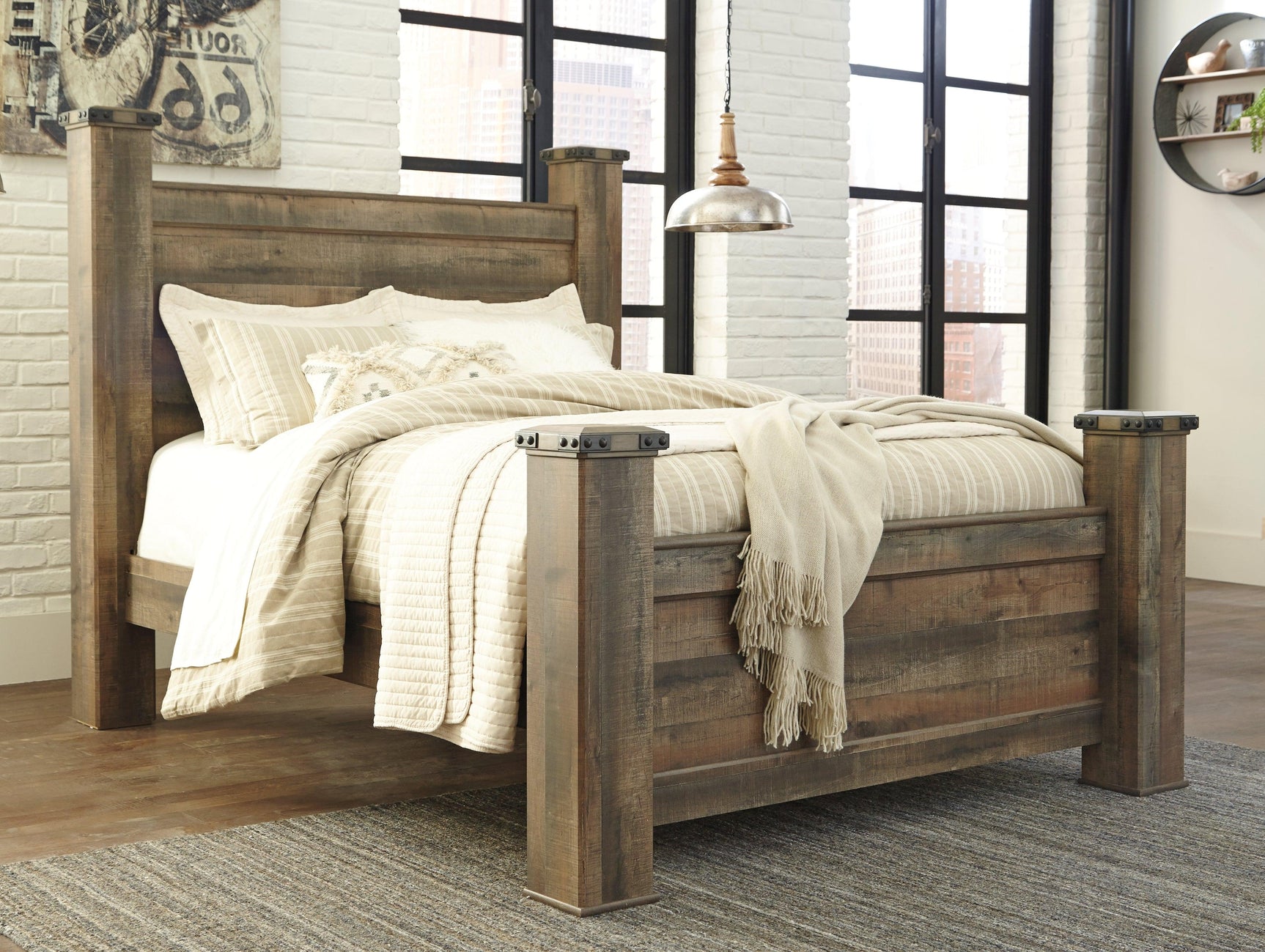 Detail of nailhead trim on Trinell Brown Queen Poster Bed posts