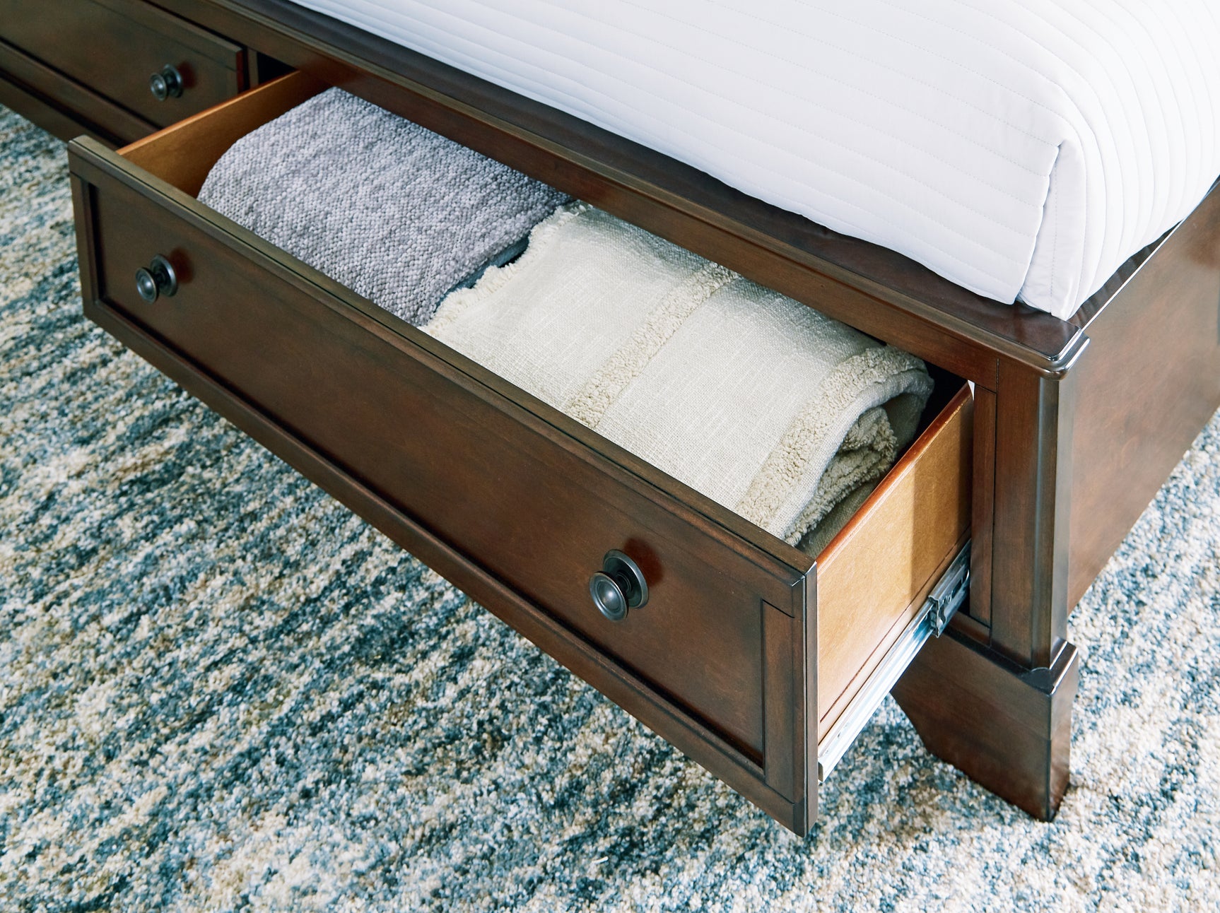 Trellington Brown King Sleigh Storage Bed footboard drawer detail