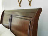 Close-up of wood finish and dark bronze-tone knobs