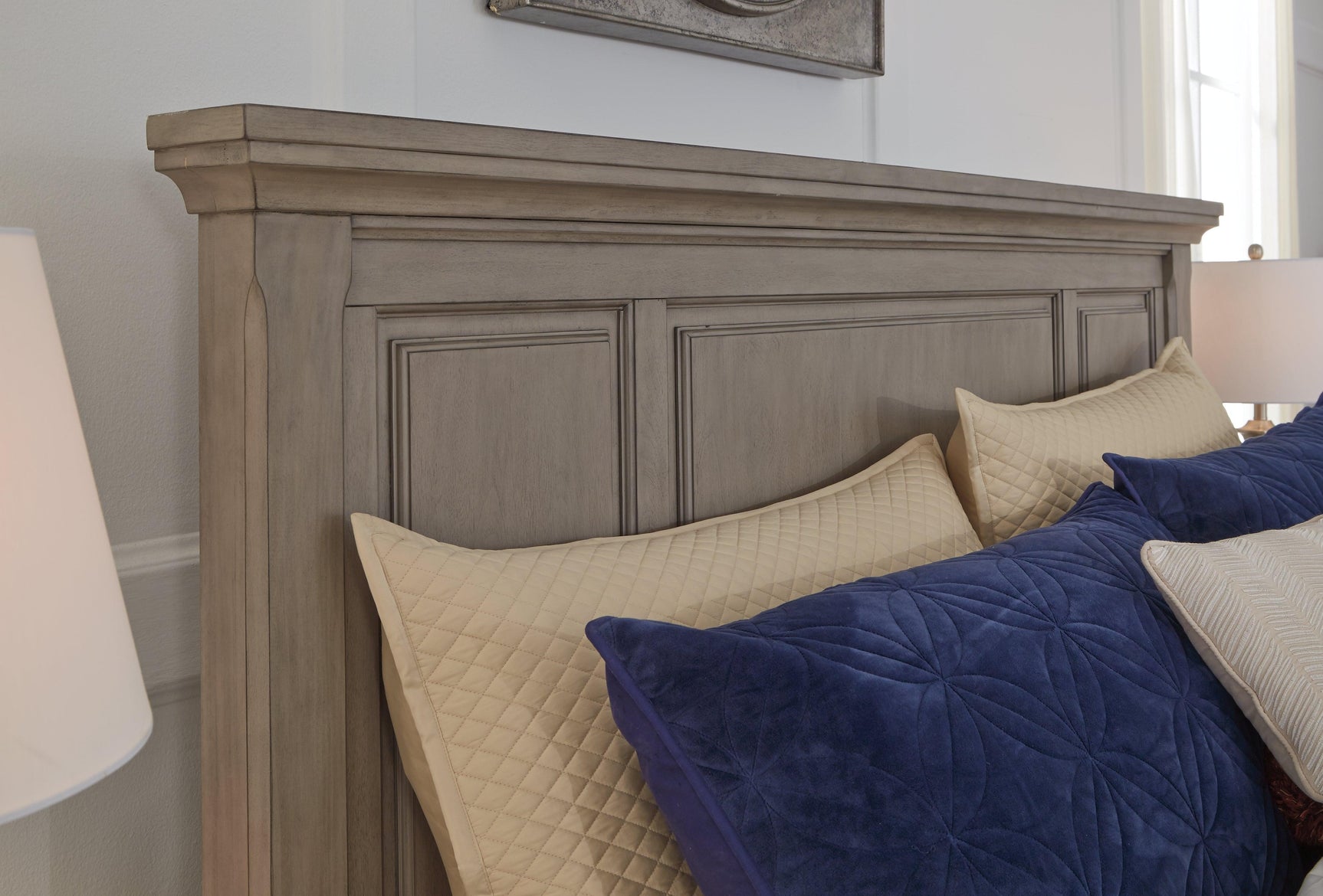 Detail of light gray finish and inlaid panel on sleigh headboard