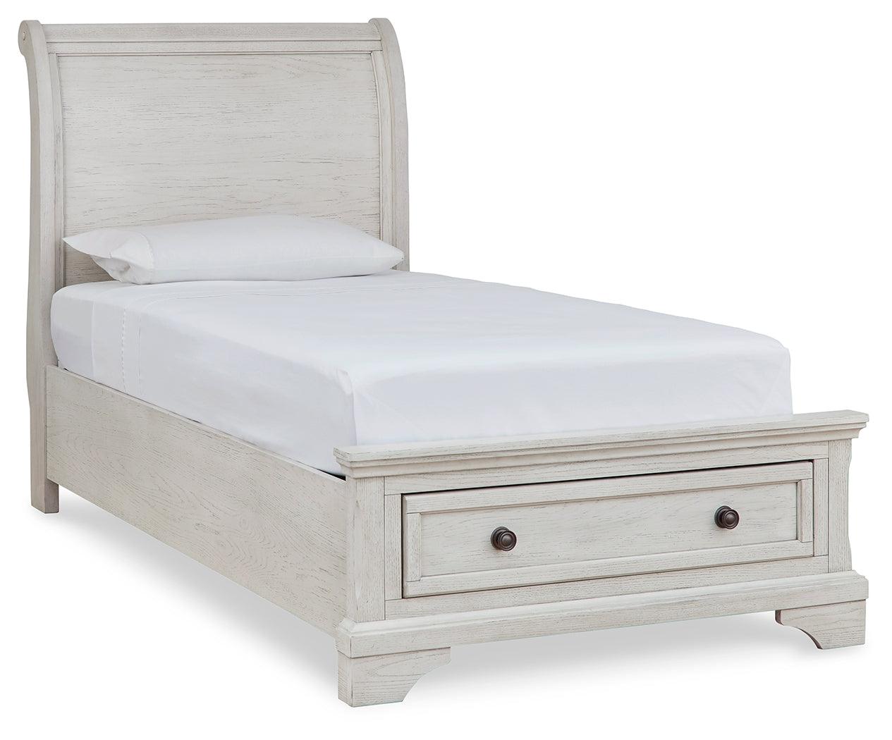 Side angle of Robbinsdale antique white twin sleigh storage bed