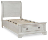 Close-up of storage drawer with bronze-tone knob on twin sleigh bed