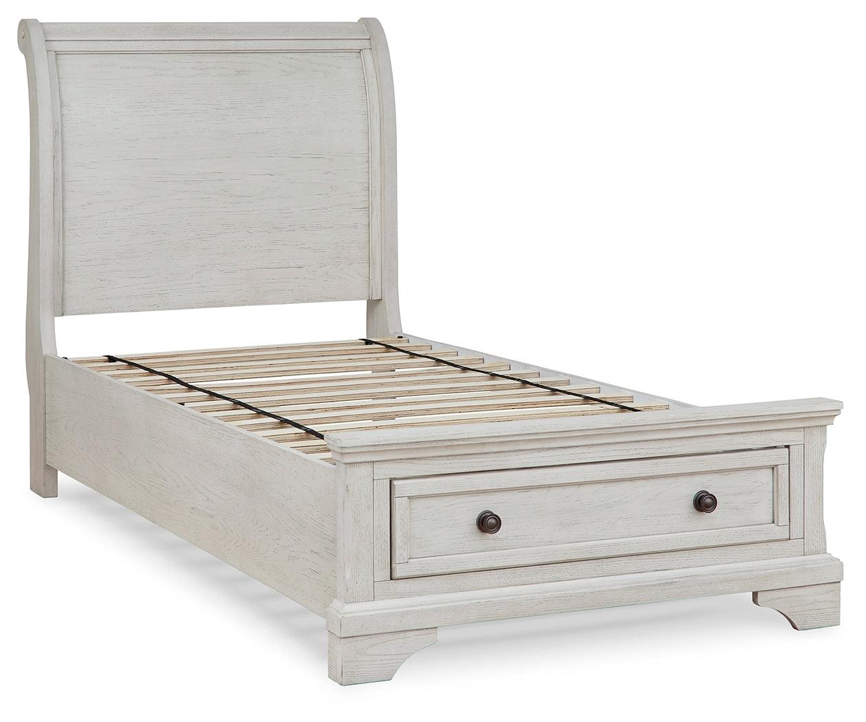 Close-up of storage drawer with bronze-tone knob on twin sleigh bed