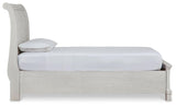 Side profile of antique white twin sleigh bed showing footboard detail
