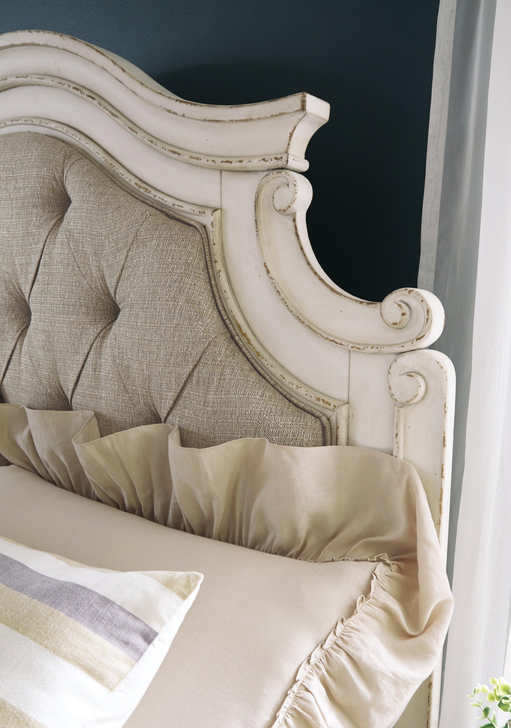 Close-up of chipped white distressed finish on bed frame