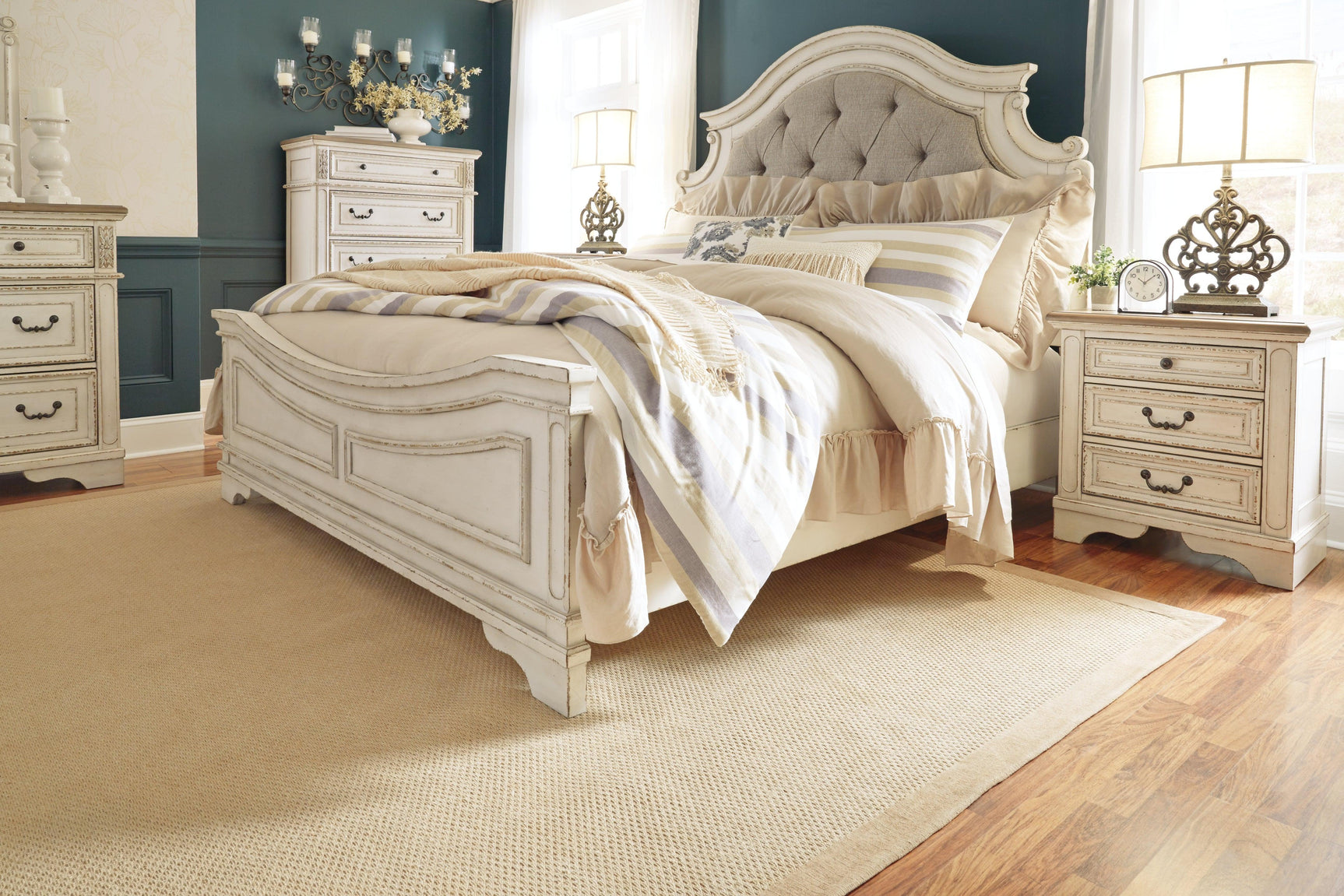 Realyn King Upholstered Bed staged in bedroom setting