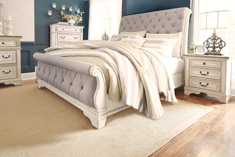 Realyn Chipped White Queen Upholstered Sleigh Bed styled in bedroom setting
