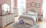 Detailed look at distressed chipped white finish on bed frame