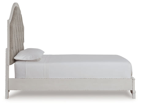 Detail of bed upholstery and rustic brown finish