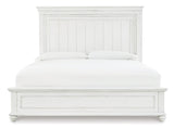 Full view of Kanwyn Whitewash King Panel Bed in bedroom setting