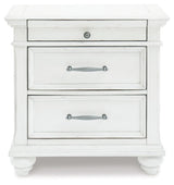 Kanwyn Whitewash Nightstand side view with bun feet