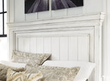 Side view of Kanwyn King Panel Bed showing bun feet and panel footboard