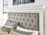 Button tufted fabric upholstery and nailhead trim detail