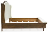 Side angle showing turned feet and bench footboard upholstery