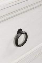 Close-up of pewter-tone ring pull hardware on chest of drawers