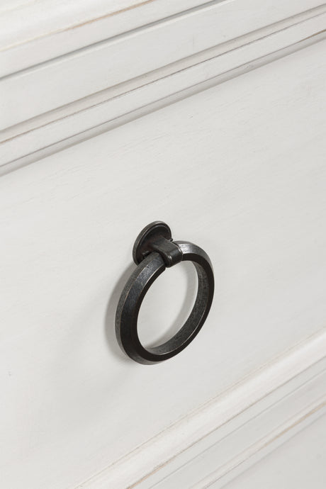 Close-up of pewter-tone ring pull hardware on chest of drawers