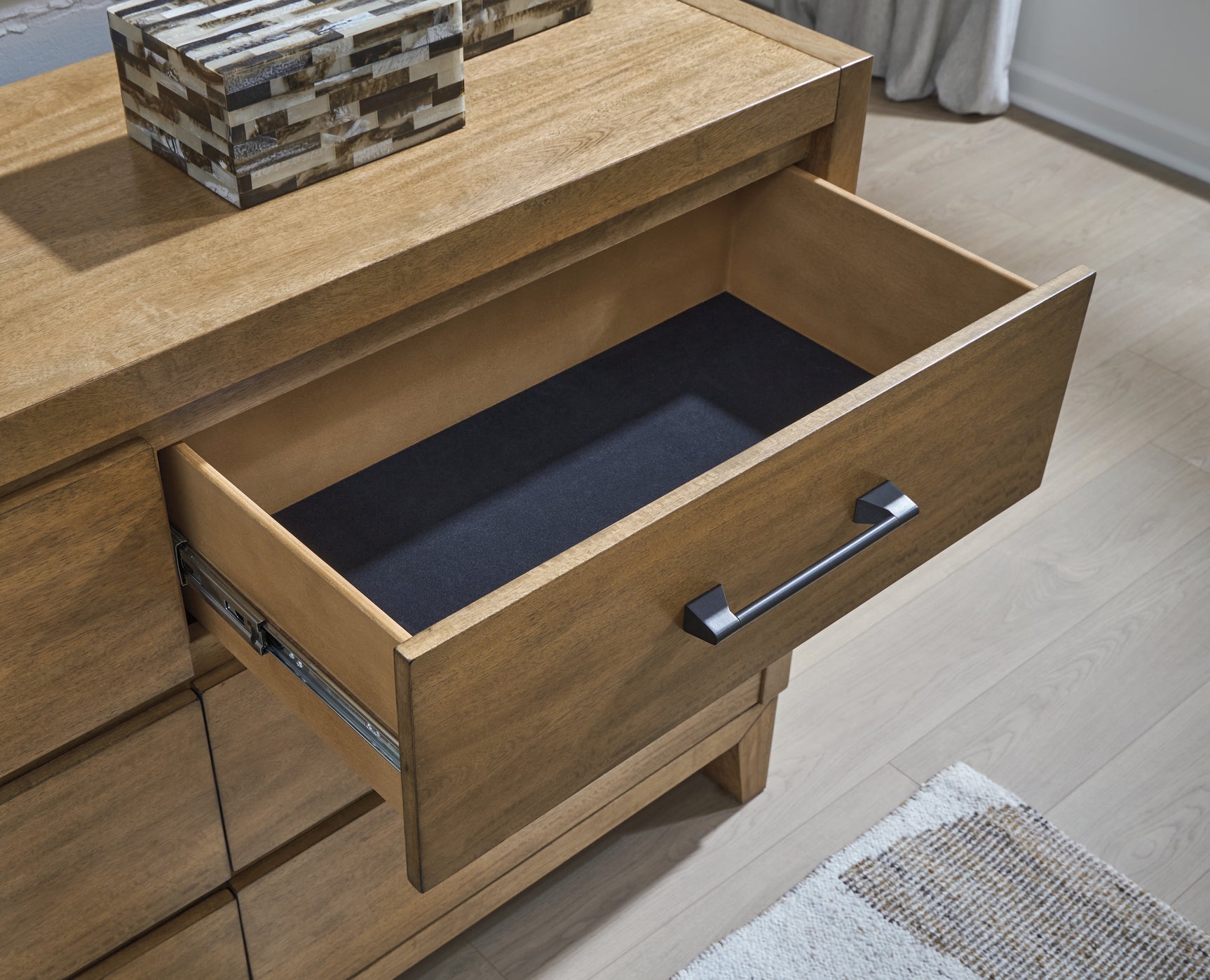 Close-up of Sherbana dresser drawer detail with dark bronze pull