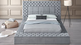 Close-up of tufted grey fabric headboard with built-in Bluetooth speakers