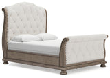 Ardenfield Queen Upholstered Sleigh Bed angled side view showing curves