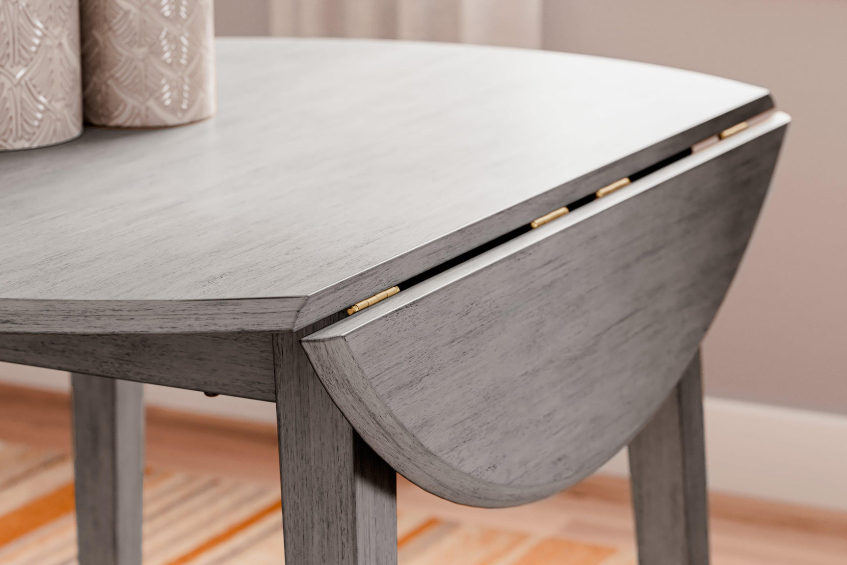 Shullden Gray Drop Leaf Dining Table by Ashley – corner detail with medium gray finish