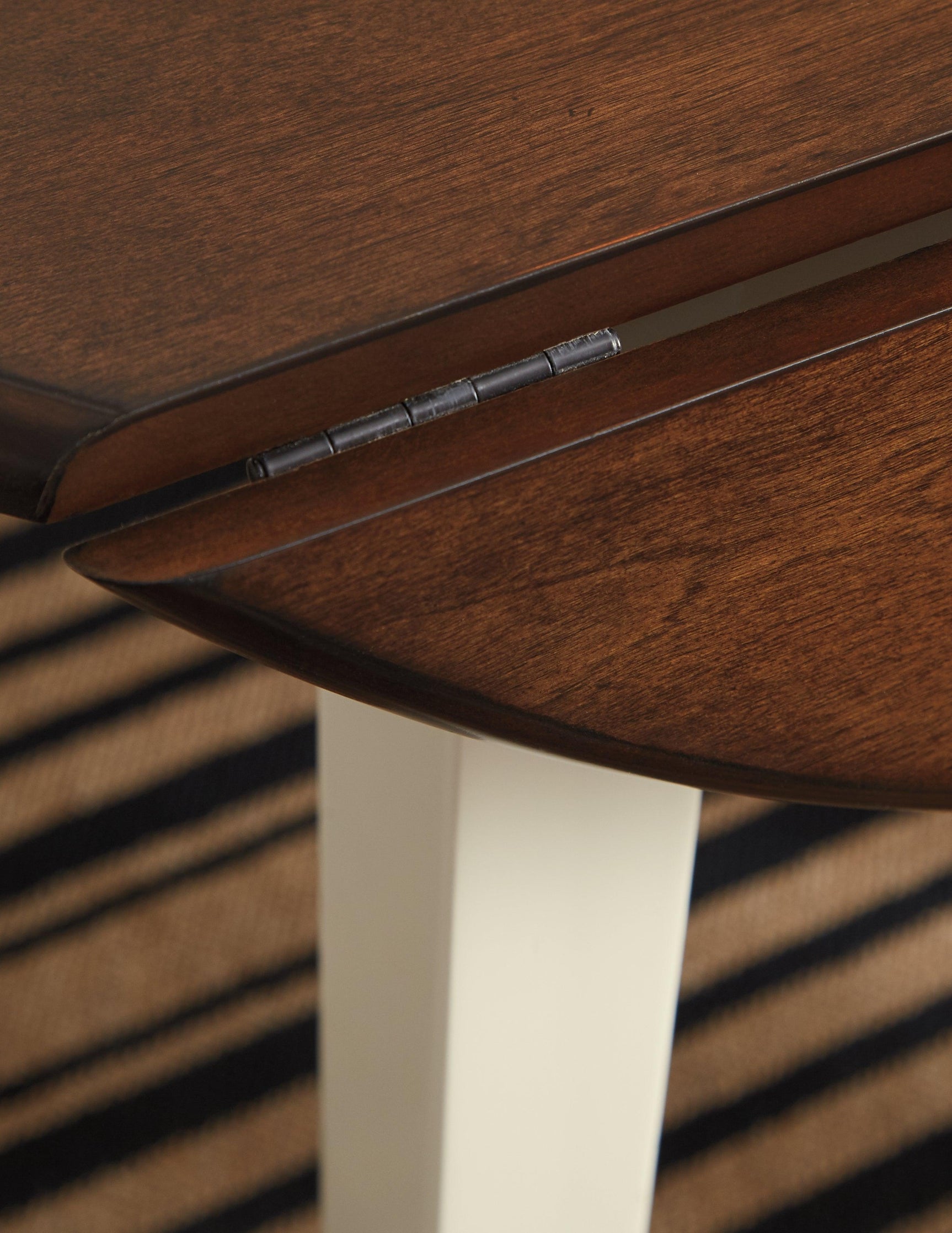 Close-up of table edge showing two-tone finish