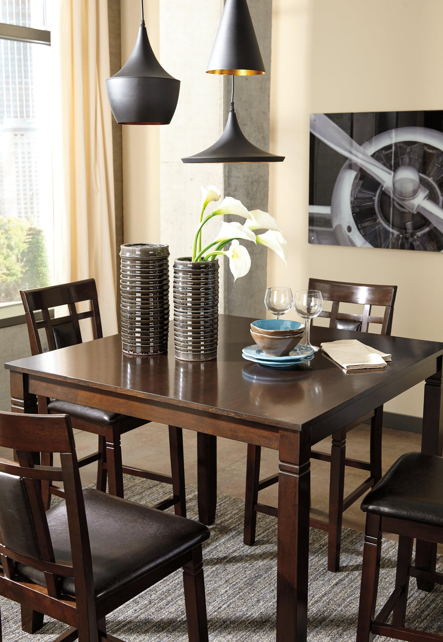 Dining set in a home kitchen setting with stools tucked under table