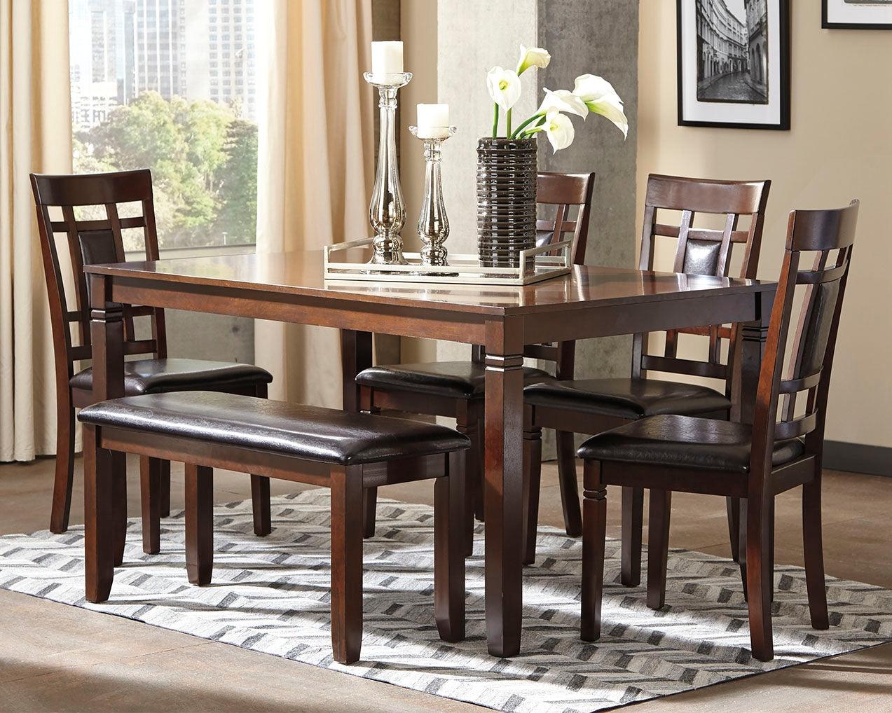 Bennox brown rectangular dining table with four upholstered chairs and bench