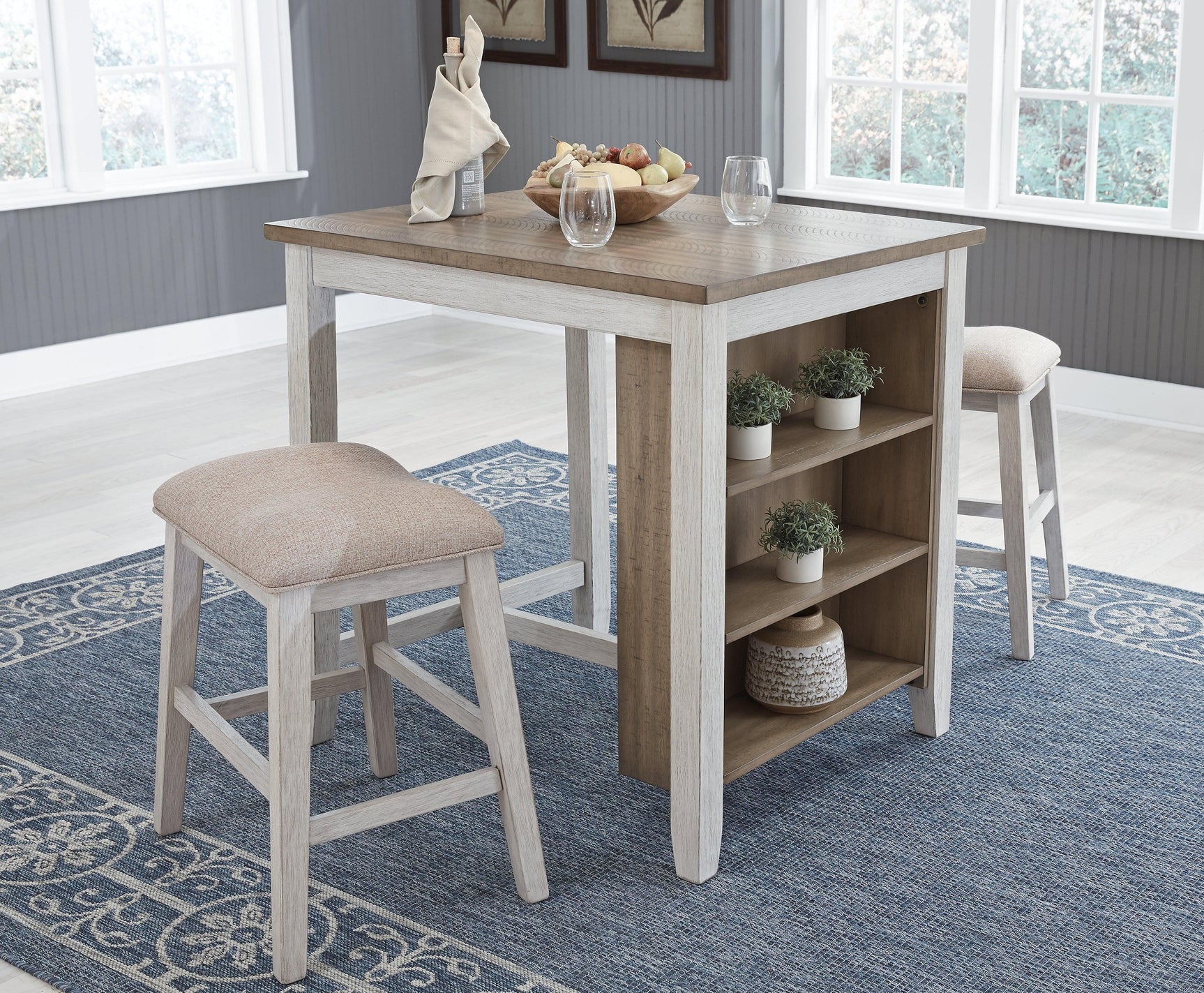 Two cushioned backless bar stools with light brown upholstery and wooden legs