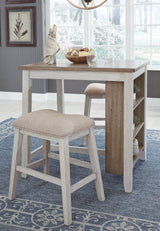 Detail of distressed grayish white finish on table base and light brown table top