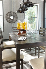 Rokane dining table showing rough sawn brown wood finish
