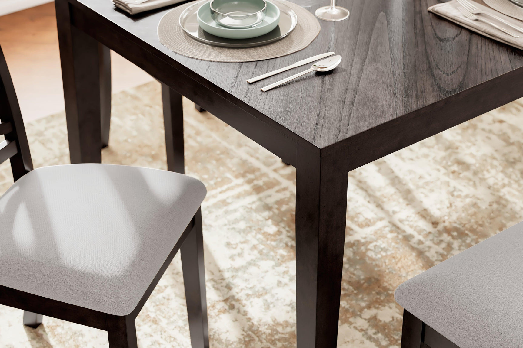 Close-up detail of Langwest dining table corner and chair upholstery