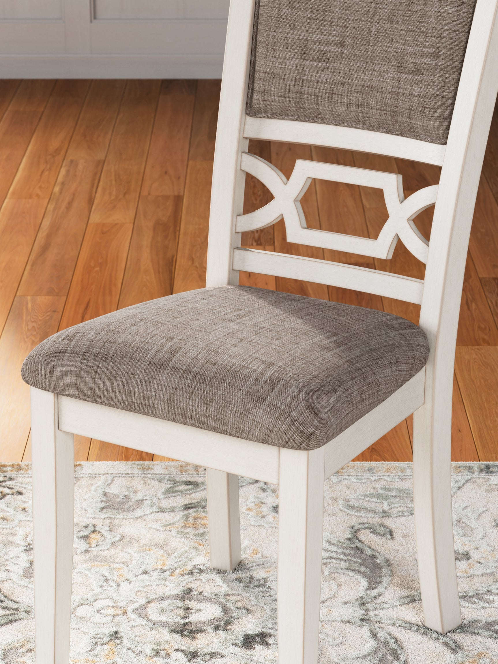 Detail of light gray textured upholstery on dining chair
