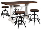 Close-up of pine wood brown tabletop and distressed vintage white base with black metal footrests