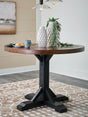 Valebeck dining table angled side view showing two-tone finish