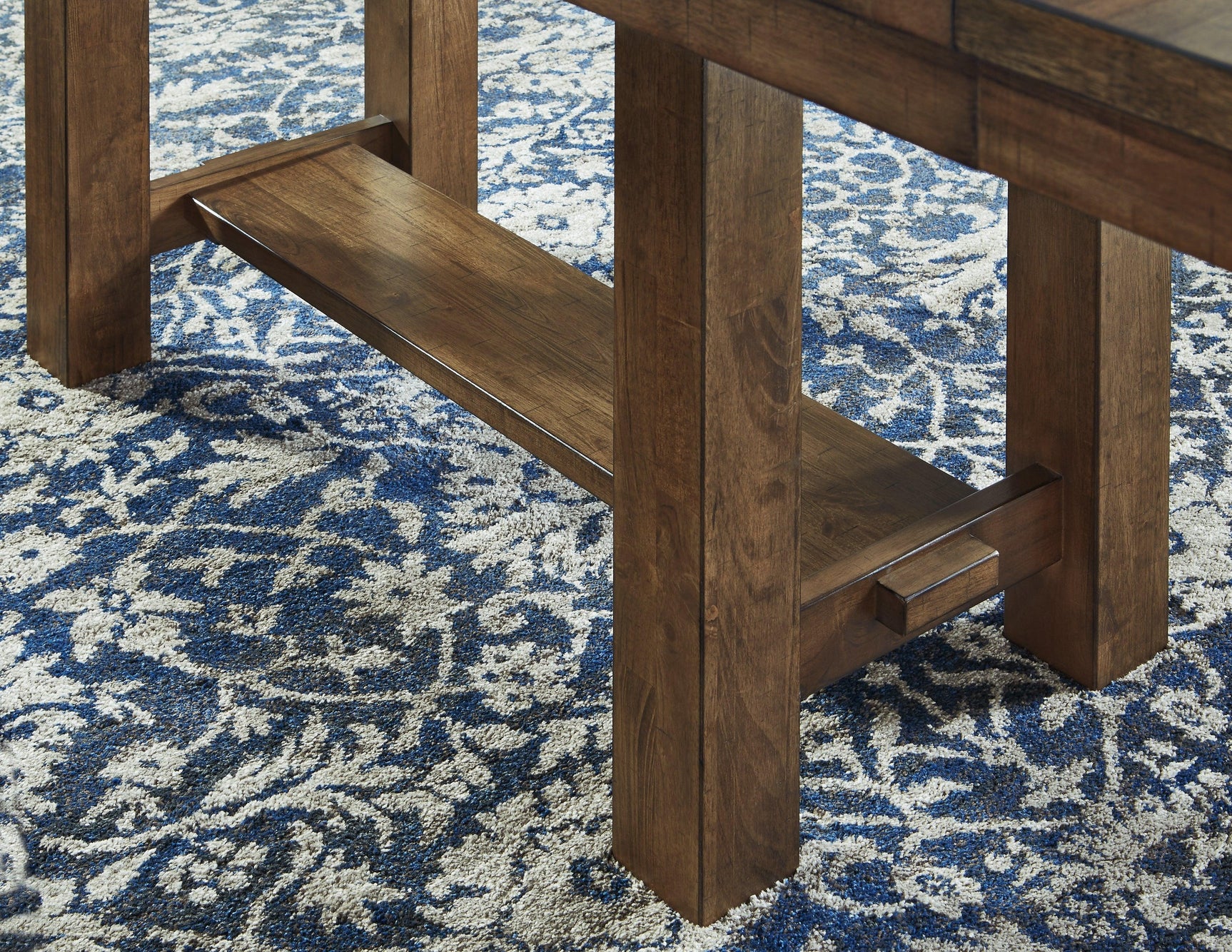 Base detail with trestle design in grayish brown finish