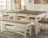 Close-up of the weathered oak tabletop and antique white base on Bolanburg Table