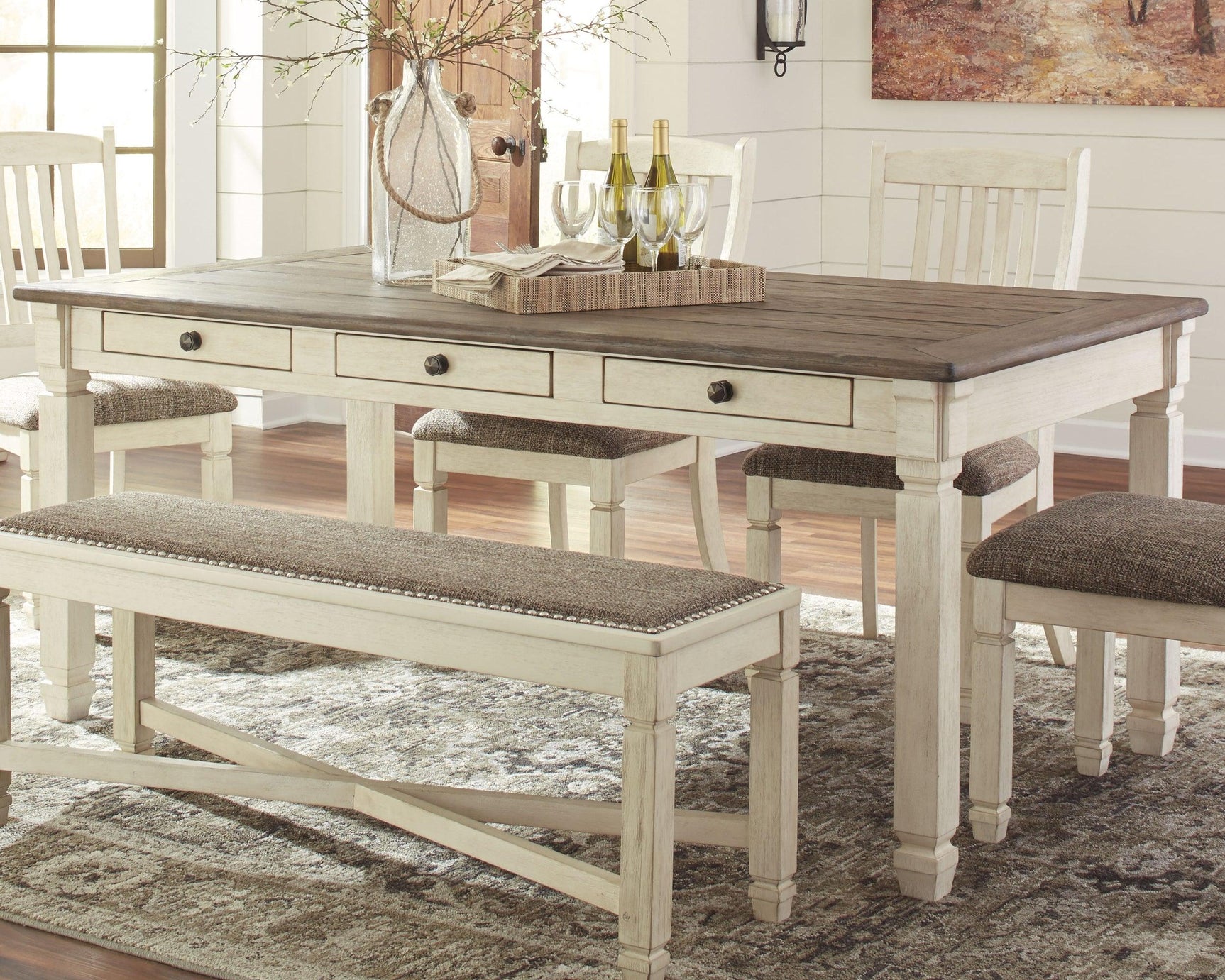 Close-up of the weathered oak tabletop and antique white base on Bolanburg Table