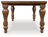 Side view of Greddinton Brown Dining Table showcasing turned leg